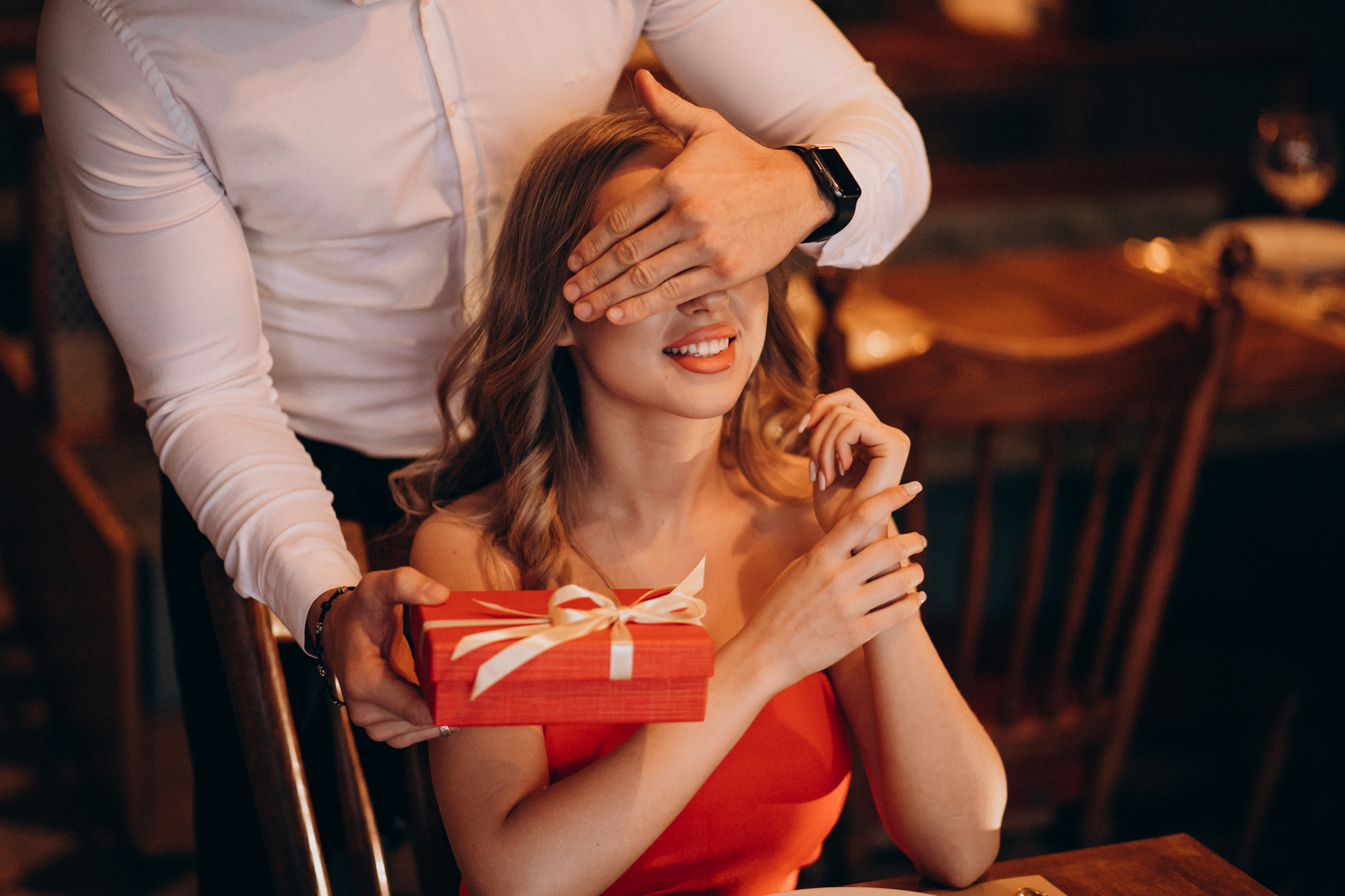 man-giving-gift-box-valentines-day-restaurant.jpg