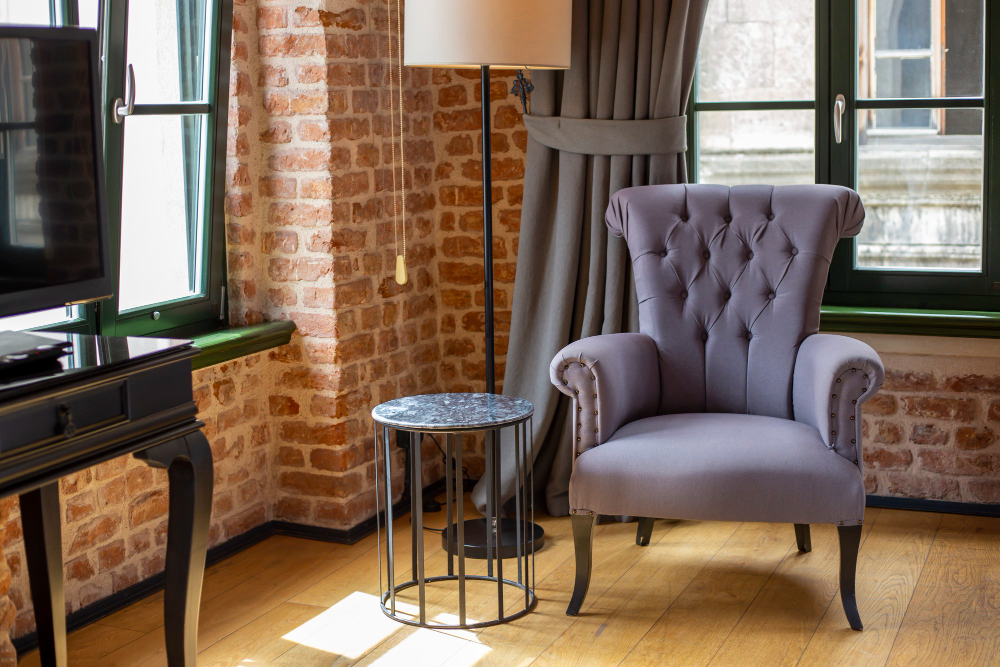 purple-armchair-stands-near-window-tea-table-room-with-red-brick-walls.jpg