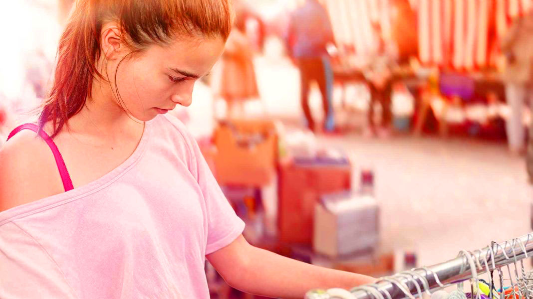 teenage-girl-looking-clothes-flea-market-1068x6002.jpg