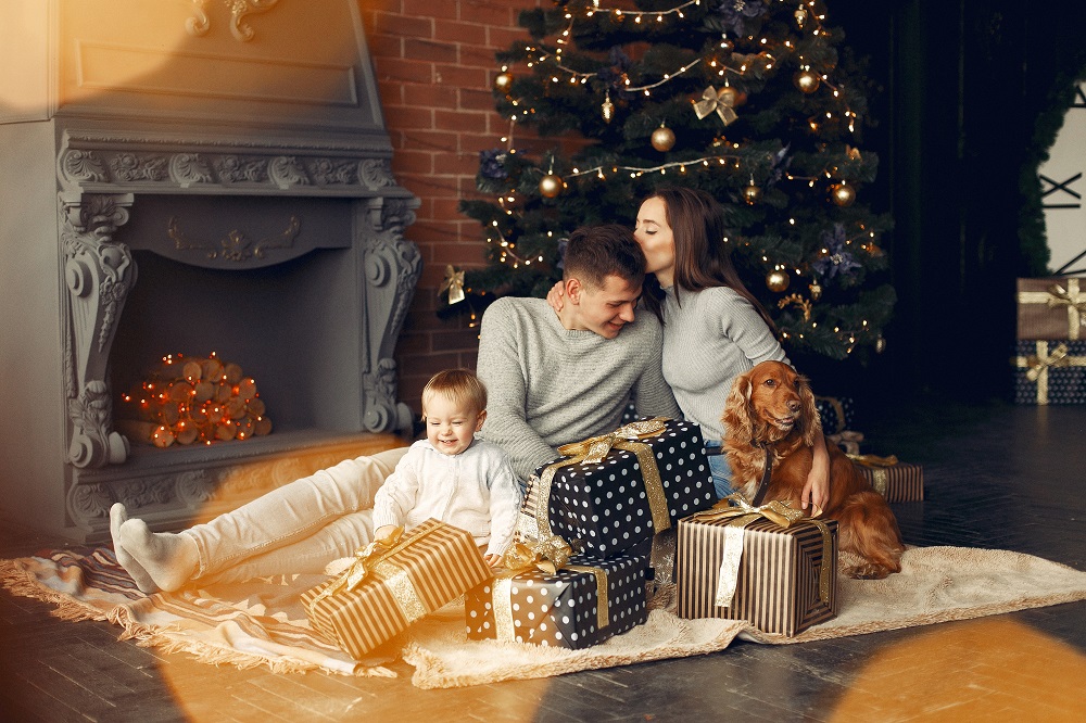 family-with-cute-dog-home-near-christmas-tree.jpg