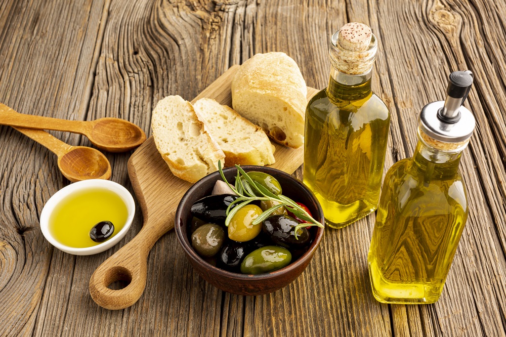 high-angle-olives-mix-bread-oil-bottles.jpg