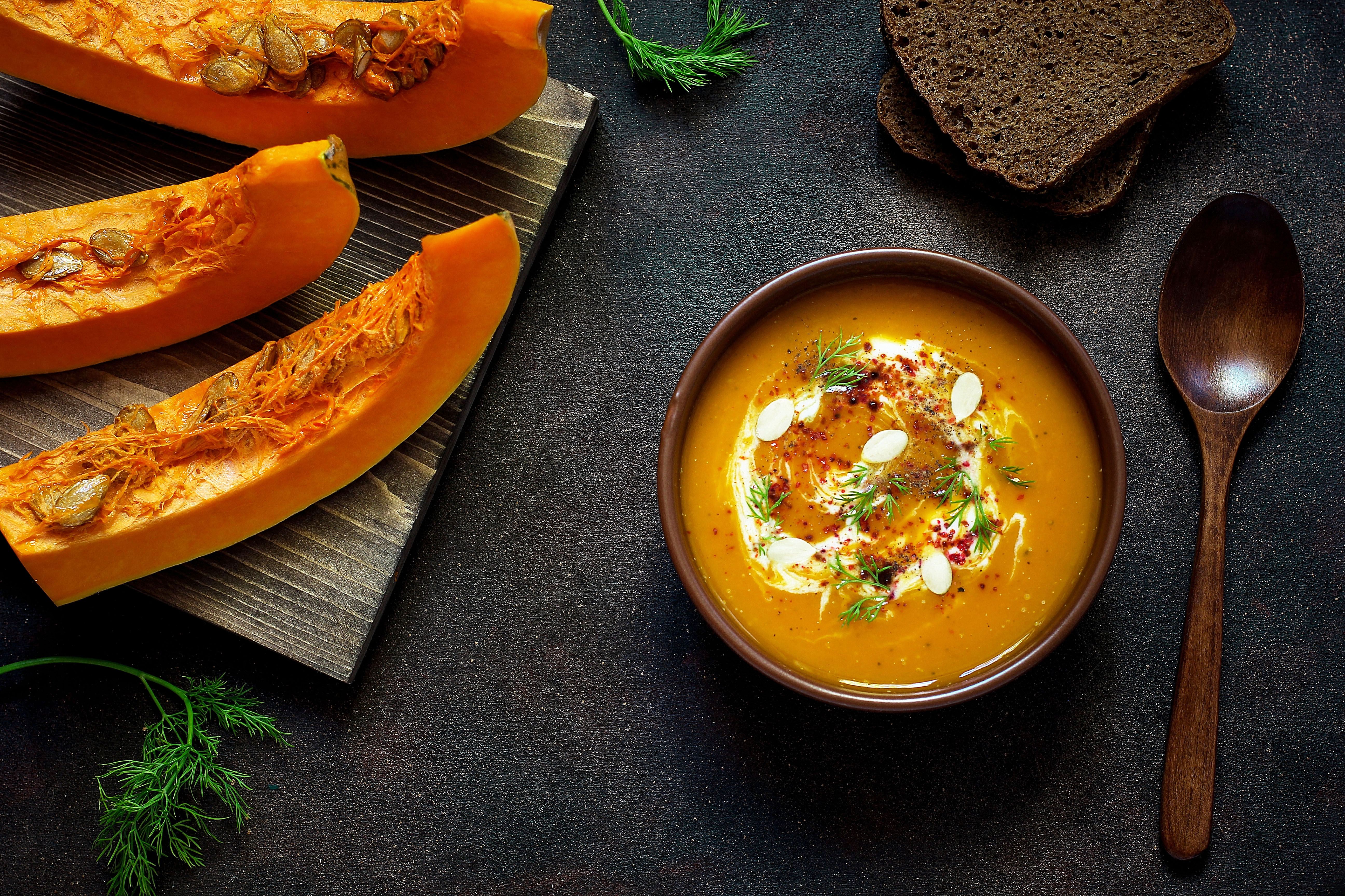 roasted-pumpkin-carrot-soup-with-cream-seeds-fresh-green-ceramic-bowl-top-view.jpg