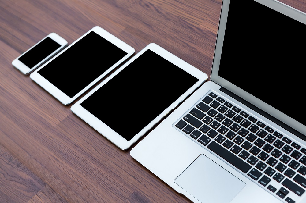 smartphone-tablets-laptop-wooden-table.jpg