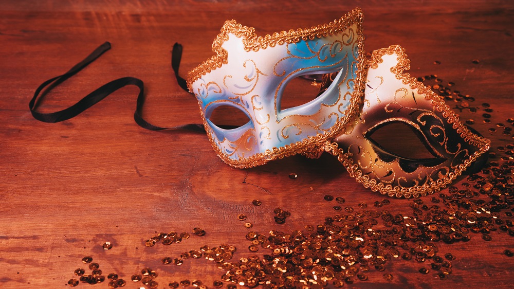 two-blue-golden-carnival-mask-with-glittering-sequins-wooden-desk.jpg