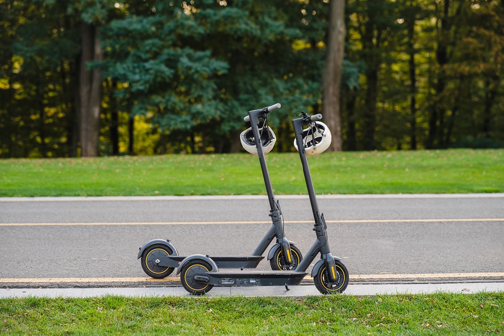 two-electric-kick-scooters-e-scooter-parked-sidelines-road.jpg