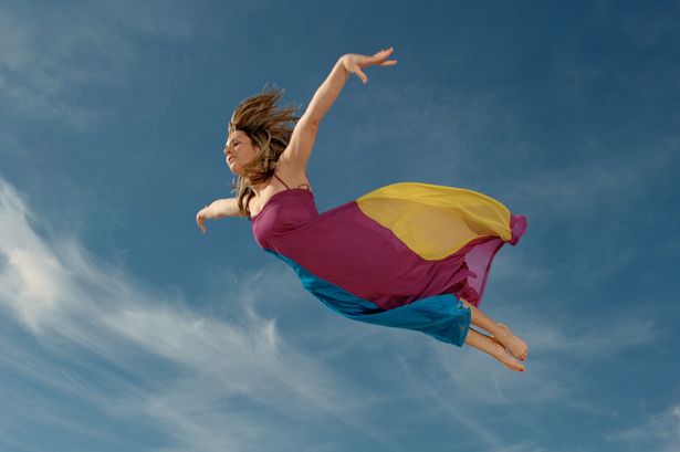 Woman flying through sky, side view.jpg