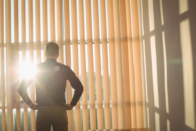 man-standing-with-hands-hip-near-window-blinds.jpg