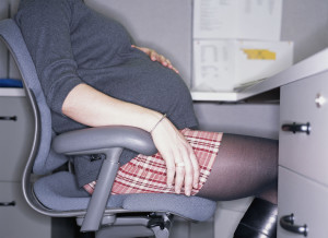 pregnant-woman-sitting-at-desk-main1-300x218.jpg