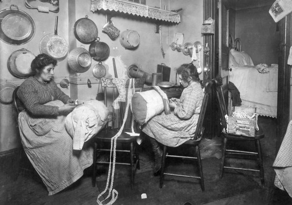 Lewis Hine - Mrs. Palontona and 13 year old daughter, Michaeline, working on -Pillow-lace- in dirty kitchen of their tenement home. New York, New York, 1911