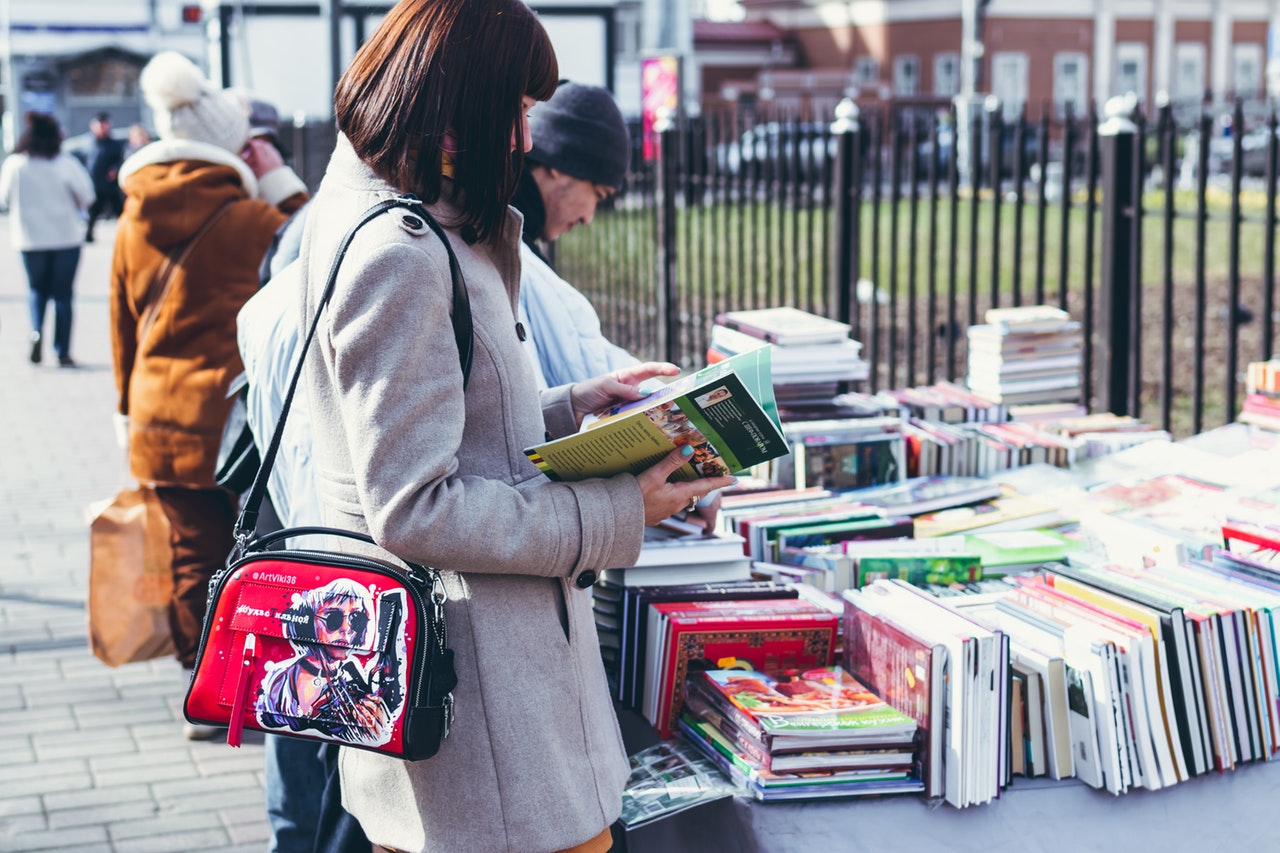 woman-wearing-coat-holding-book-2115426_1.jpg