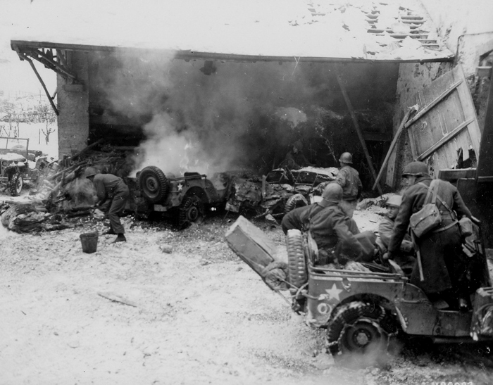 Burning jeeps 26th Inf Div after a German indirect fire attack Wiltz,.jpg