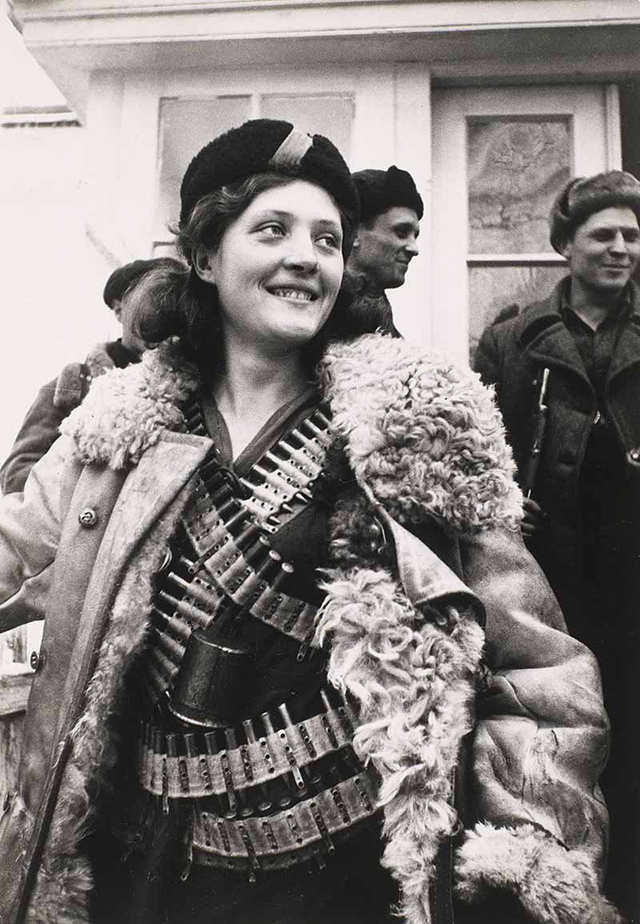 in-1942-a-russian-female-partisan-stands-covered-in-ammunition.jpg