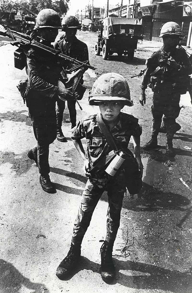 little-tiger-a-child-soldier-rumored-to-have-killed-his-mother-and-his-teacher-stands-for-a-photograph-in-1968.jpg