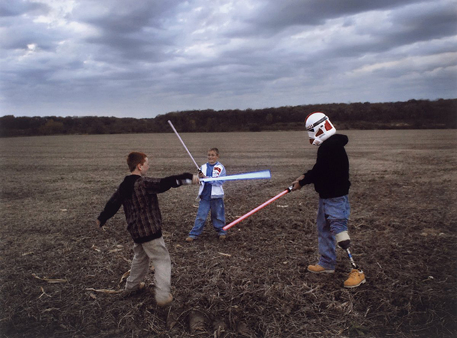 raymond-hubbard-an-iraq-war-veteran-with-a-prosthetic-leg-puts-on-a-star-wars-storm-troopers-helmet-and-engages-his-sons-in-a-light-saber-battle-in-2007-his-father-was-similarly-injured-in-vietnam.jpg