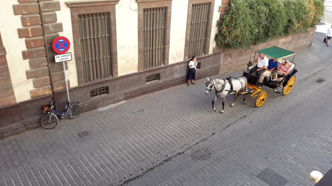 Andalúz körutazás, Sevilla, kilátás a szobánkból az utcára ahol éppen egy lovashintó halad el