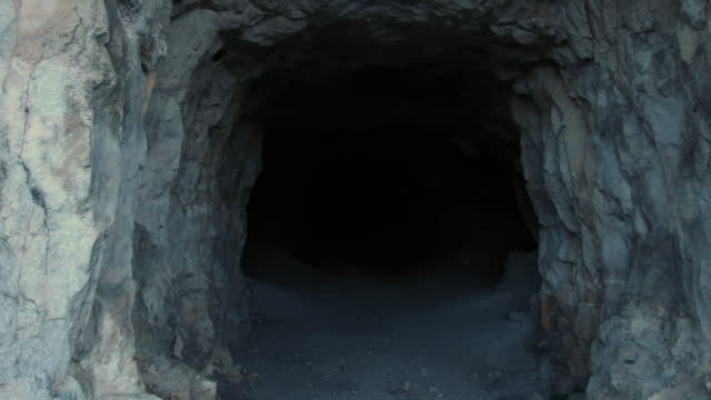 entrance-into-a-cave-in-the-mountain-with-blackout-in-the-end.jpg