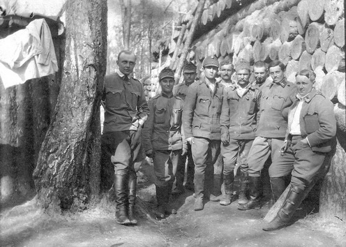 Az I. (Ghyczey) és a III. (Saxer) üteg felderítő járőrei Karpilowkánál a 13. honvéd gyalogezred körletében. A kép jobb szélén, a fatörzsbunkernek támaszkodva Ötvös József hadapród a Saxer üteg, a bal szélén Kuthy vagy Palotay, az első üteg felderítője. Közöttük a két felderítő állomás telefonistái, 1916 áprilisában, a Bruszilov-áttörés előtt