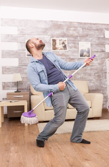 cheerful-husband-dancing-cleaning-floor-apartment_482257-64.jpg