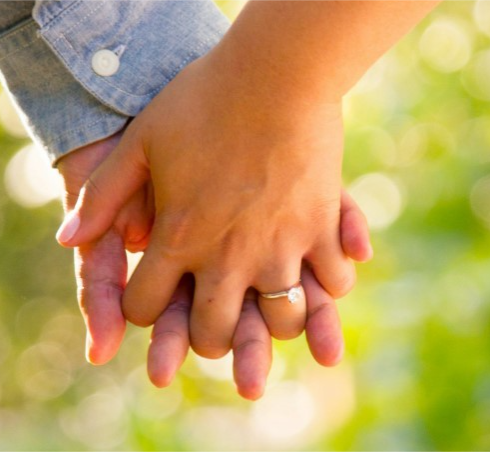 shallow focus photo of man and woman holding hands