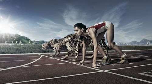 marathon_runner_girl_with_cheetah_on_race_start_line-wide.jpg