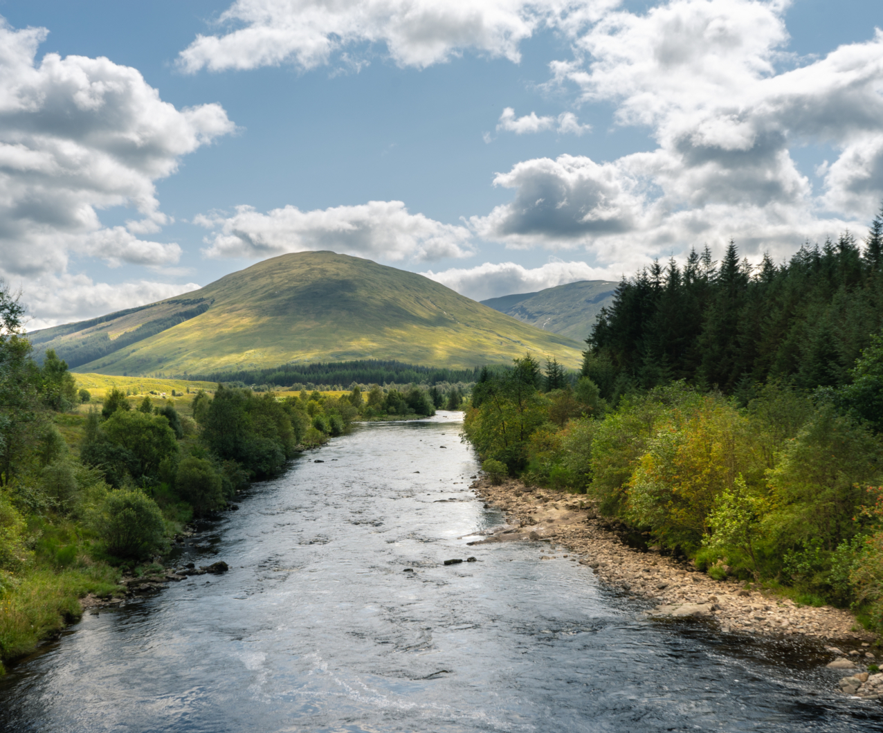 river-flowing-through-trees-mountains-scotland.jpg