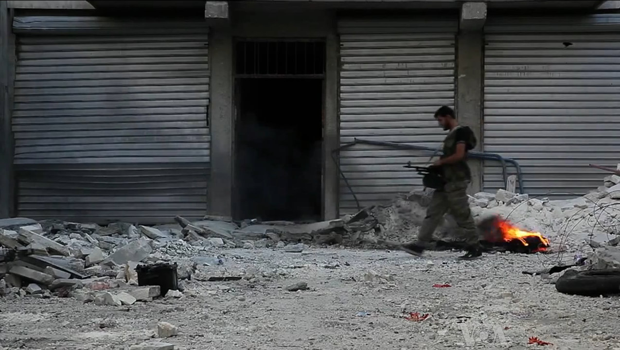 Free_Syrian_Army_soldier_walking_among_rubble_in_Aleppo.jpg