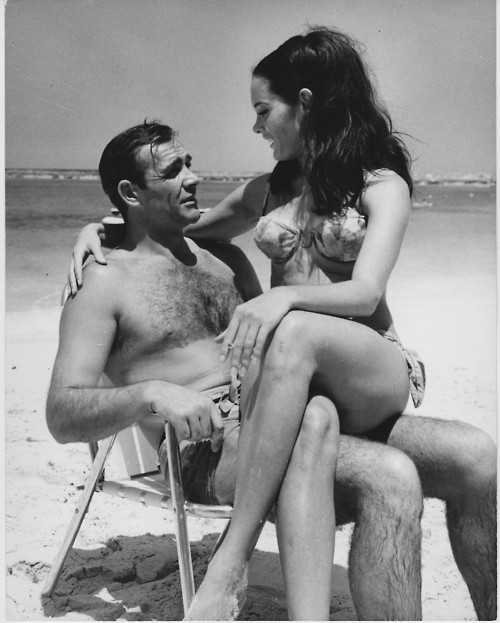 Martine_Beswick_holding_cig_with_Sean_Connery_on_set_of_Thunderball_in_1965.jpg