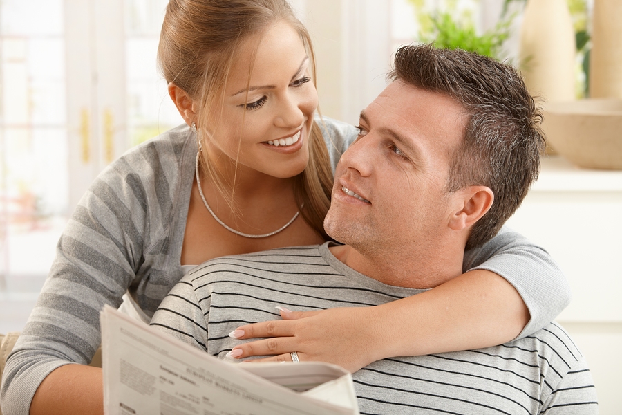 bigstock-happy-couple-sitting-at-home-l-13100603.jpg