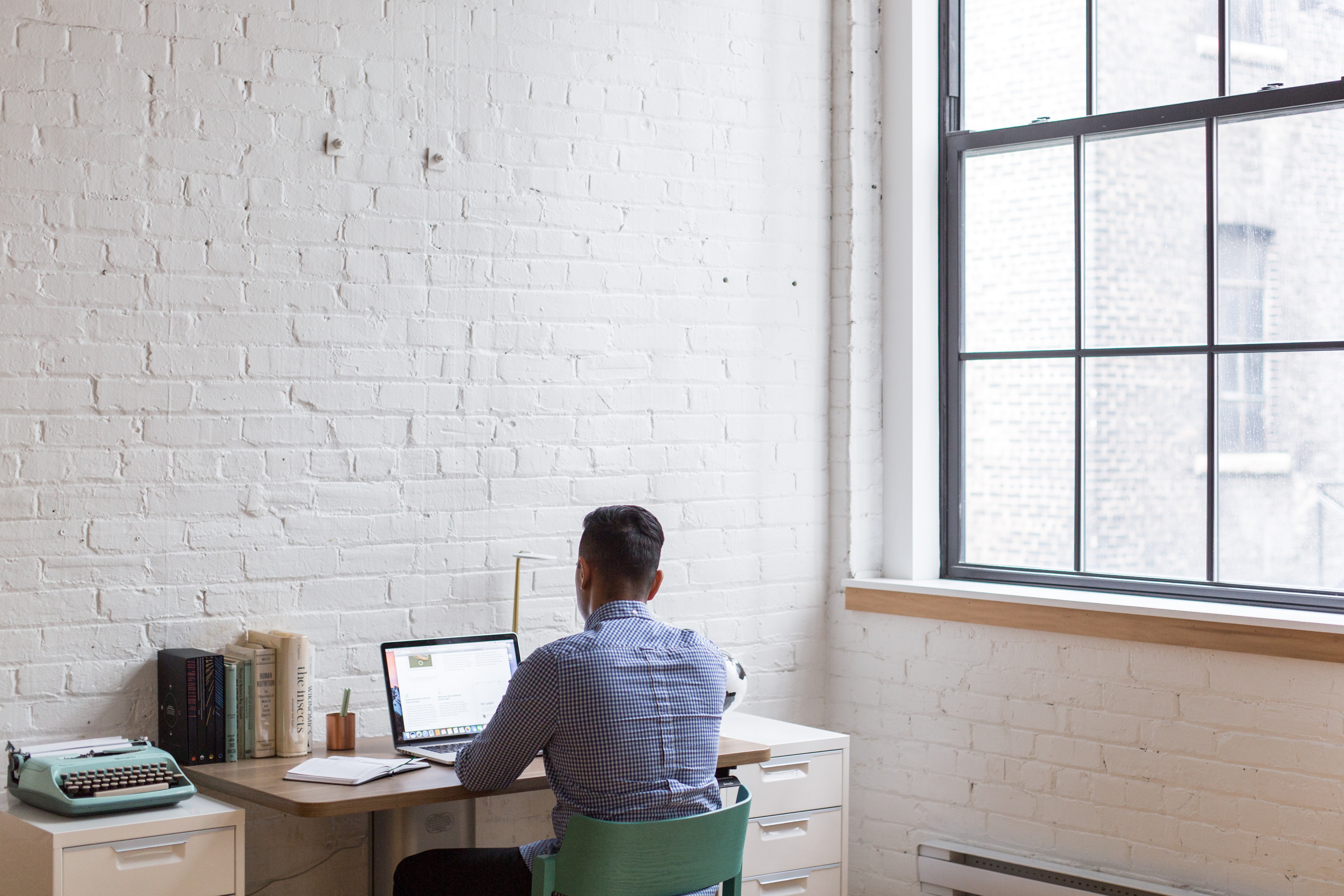 man-sitting-down-and-using-his-laptop-374085.jpg