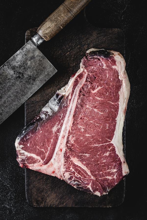 premium-dry-aged-raw-t-bone-steak-rustic-kitchen-chopping-board-usda-prime-beef-152343151.jpg