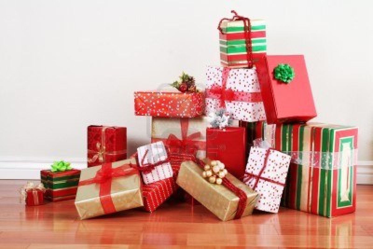 5682167-a-pile-of-christmas-gifts-in-colorful-wrapping-with-ribbons-against-the-wall-on-a-beautiful-hardoow-.jpg