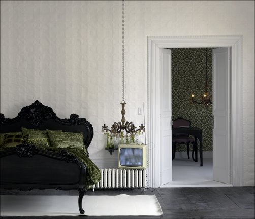 James Merrell bedroom black carved wood bed headboard frame black chandelier textured white walls.jpg