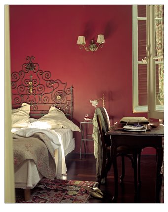 James Merrell red walls bedroom iron scroll headboard desk.jpg