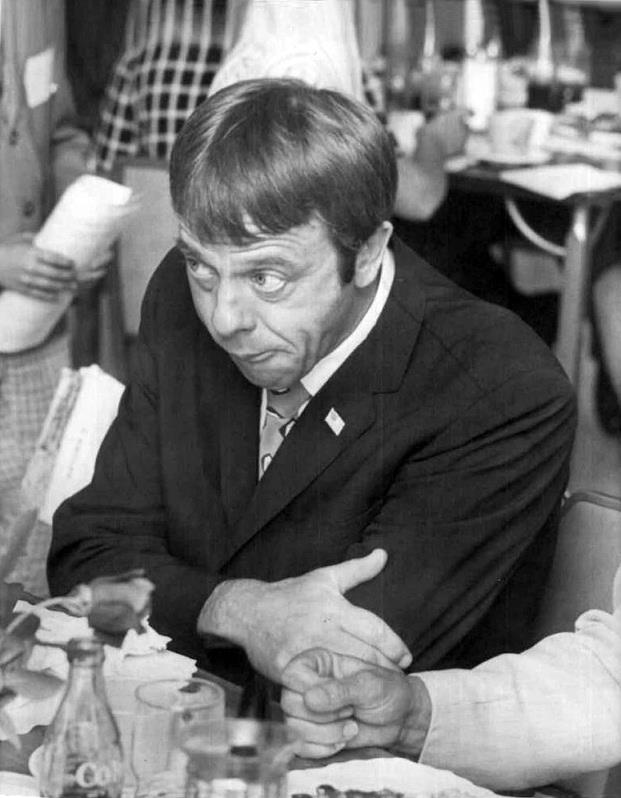Alan Shepard at dinner. Looks like a question of either not liking the food or conversation..jpg