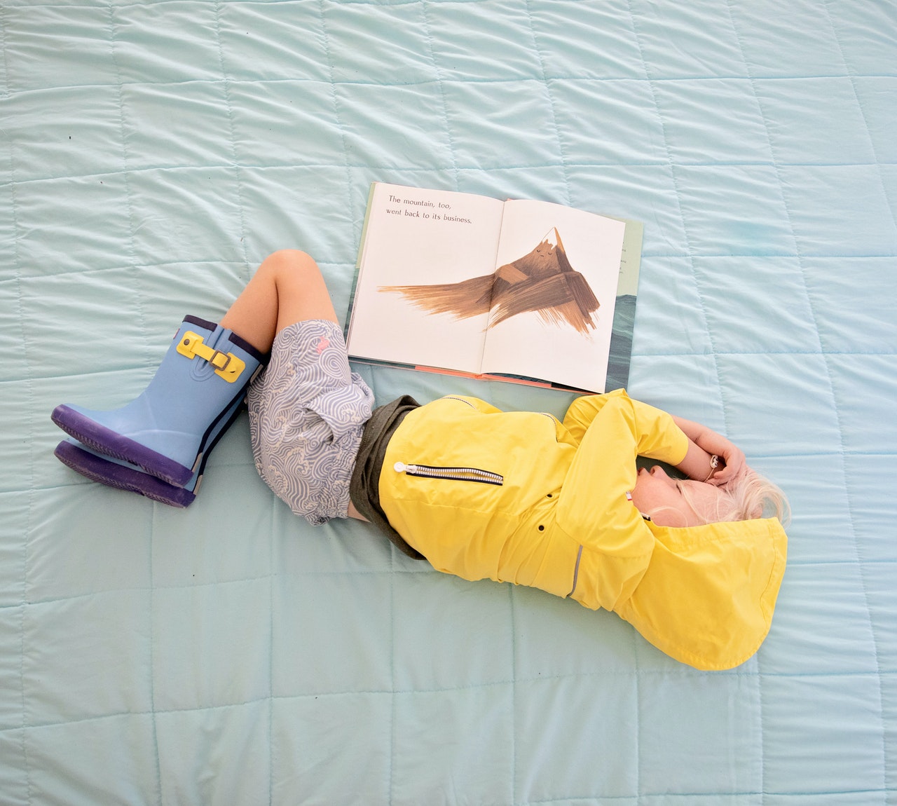 baby-in-yellow-hooded-jacket-sleeping-beside-book-2992878.jpg