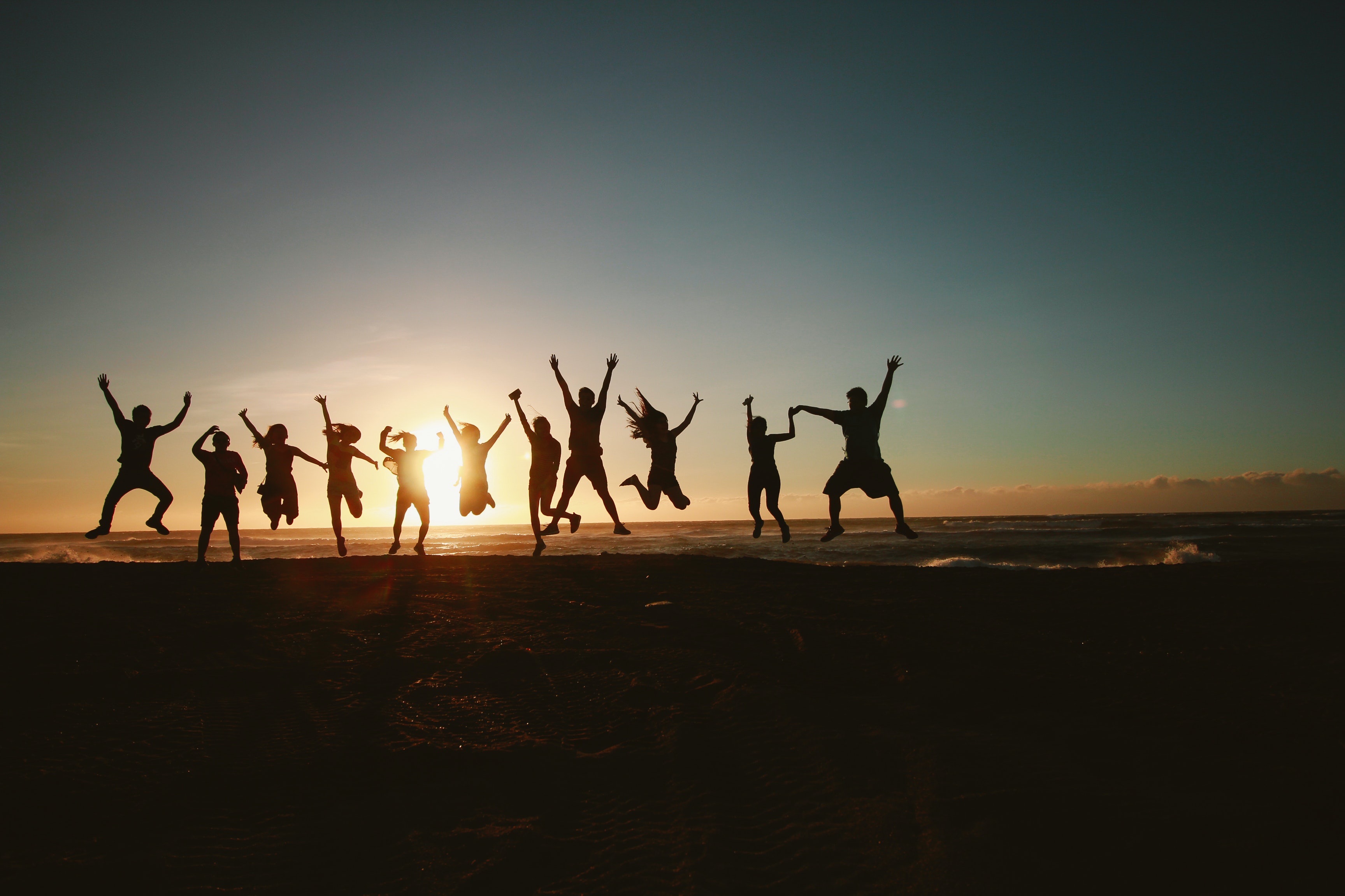 silhouette-photography-of-group-of-people-jumping-during-1000445.jpg