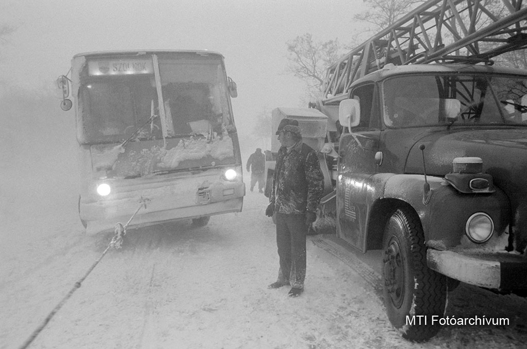 1984. február 10. Vontatóval mentik a hó fogságából a Szolnoki Volán autóbuszát a 442-es úton. Ítéletidő - hóvihar, hófúvás, hózápor tombolt Szolnok megyében. MTI Fotó: E. Várkonyi Péter