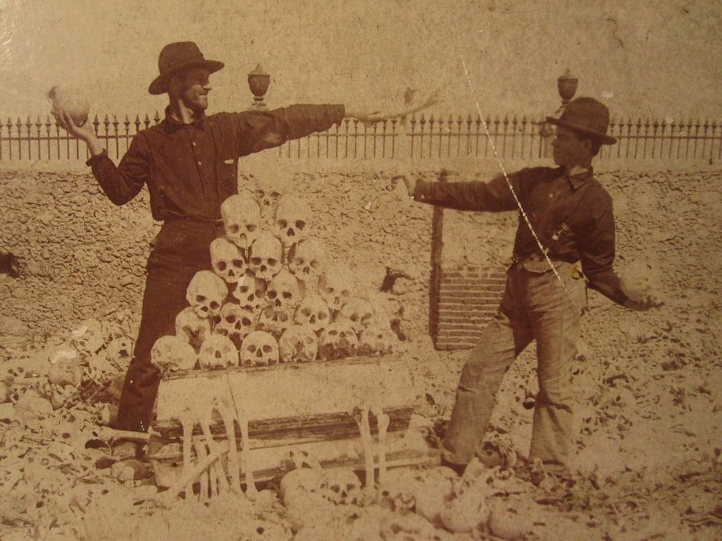 1899_american_soldiers_playing_around_with_human_skulls_in_colon_cemetery_in_havana.jpg