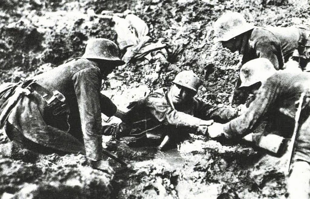 1918_german_troops_trying_to_rescue_a_french_soldier_from_sinking_in_a_mud_hole.jpg