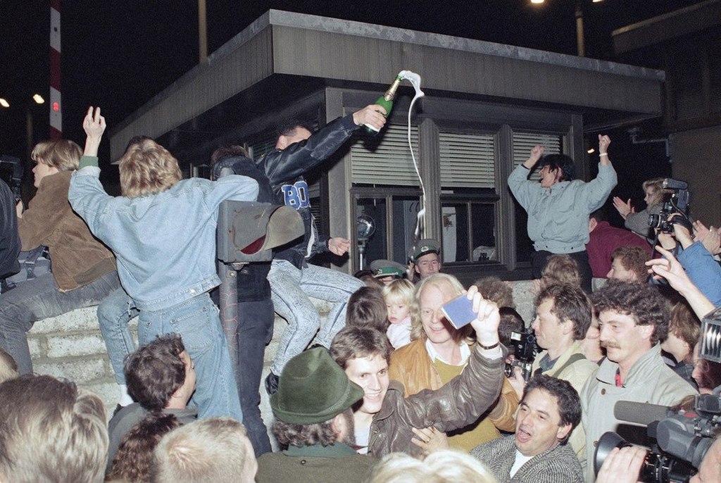 1989_berliners_celebrating_on_top_of_the_wall_as_east_germans_flood_through_the_dismantled_berlin_wall_into_west_berlin.jpg