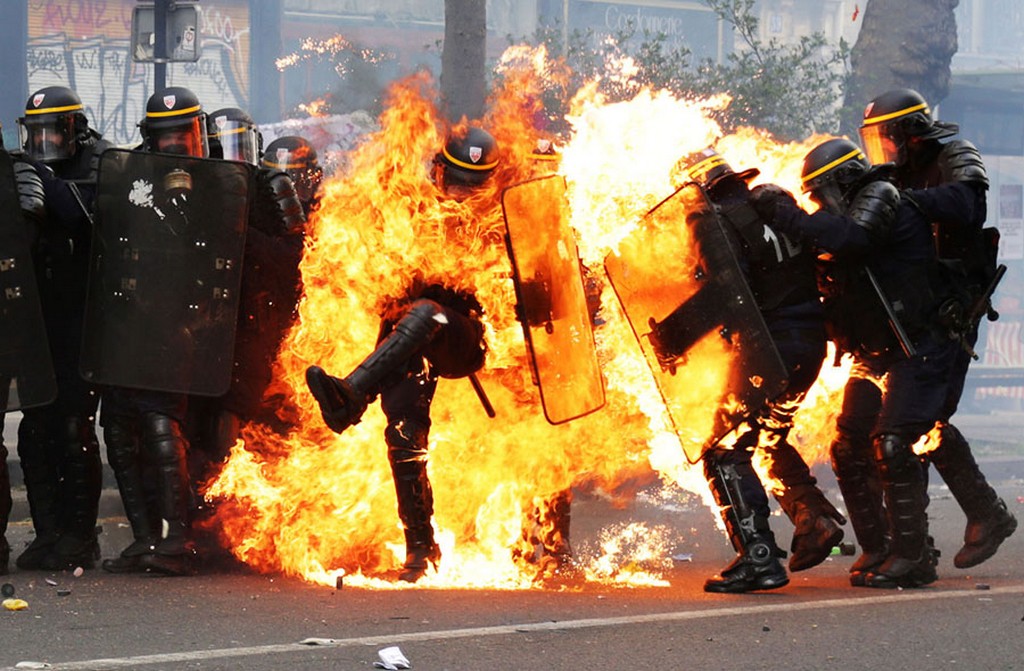 2017_05_01_french_crs_riot_police_officers_are_engulfed_in_flames_as_they_face_protesters_during_a_march_for_the_annual_may_day_workers_s_rally_in_paris.jpg
