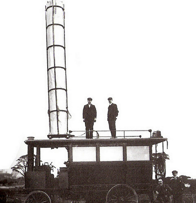 1901_guglielmo_marconi_standing_far_right_beside_the_first_motor_vehicle_to_have_a_radio_the_tube_on_the_roof_is_the_aerial.png