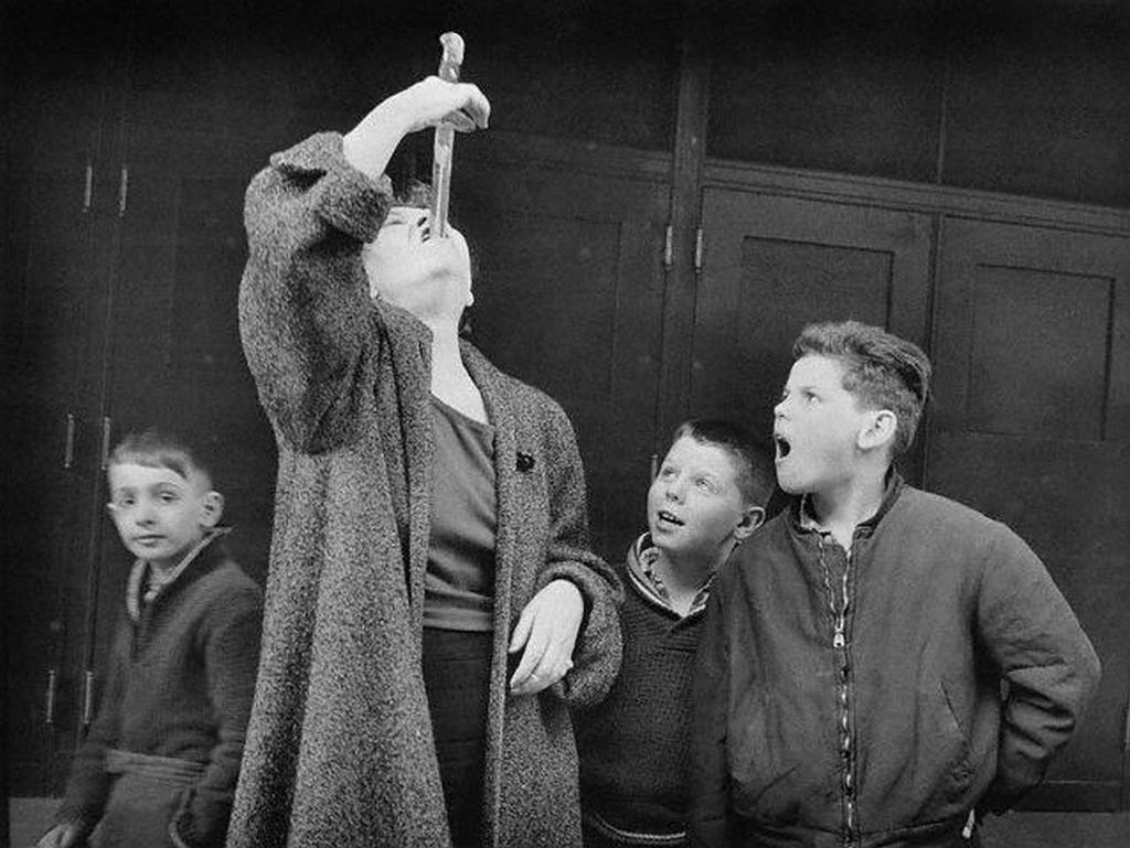 1961_estelline_pike_demonstrating_her_sword_swallowing_technique_to_children_at_ward_hall_s_world_of_wonders_sideshow_usa.jpg