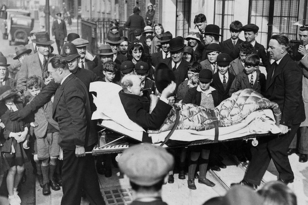 1932_winston_churchill_being_carried_into_a_nursing_home_on_a_stretcher_after_being_hit_by_a_car_in_new_york_city.jpg