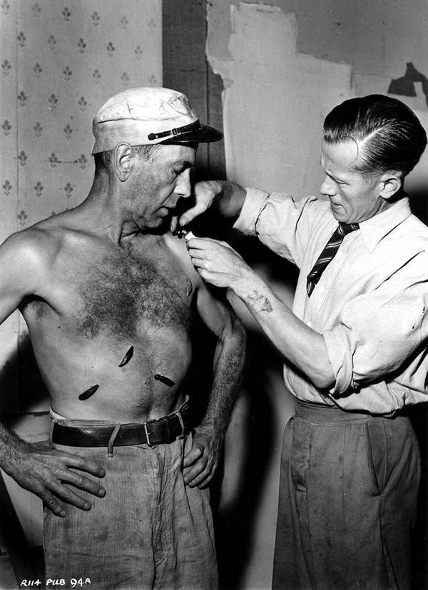 1951_humphrey_bogart_having_rubber_leeches_applied_to_his_chest_for_the_filming_of_the_african_queen.jpg