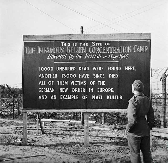 1945_a_sign_erected_by_british_forces_at_the_entrance_to_bergen-belsen_concentration_camp.jpg