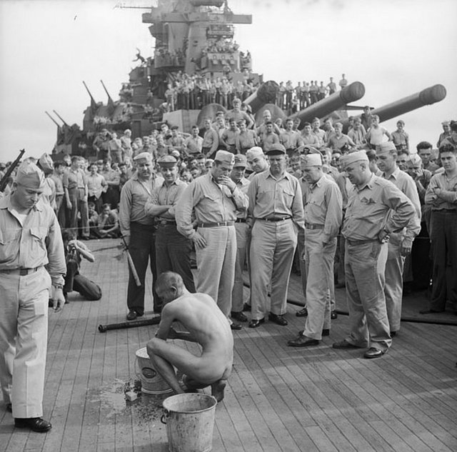 1944_japanese_prisoners_of_war_are_bathed_clipped_deloused_and_issued_gi_clothing_as_soon_as_they_are_taken_aboard_the_uss_new_jersey.jpg