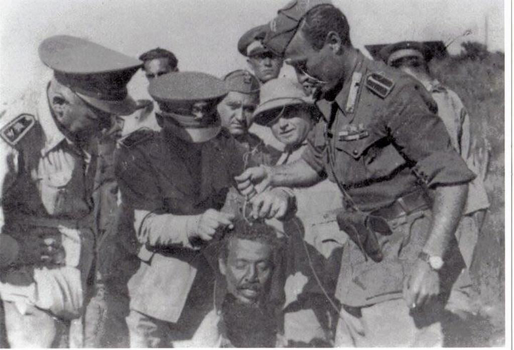 1937_fascist_italians_holding_the_head_of_ethiopia_first_general_hailu_kebede_before_they_sent_it_to_rome_for_mussolini_to_see_it.jpg