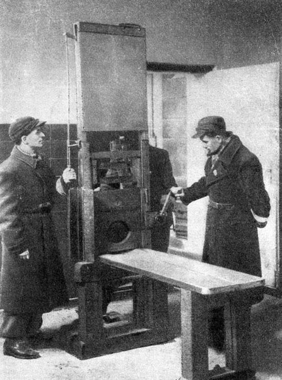 1945_soviet_soldiers_examine_the_nazi_guillotine_left_behind_after_the_capture_of_poznan_poland.jpg