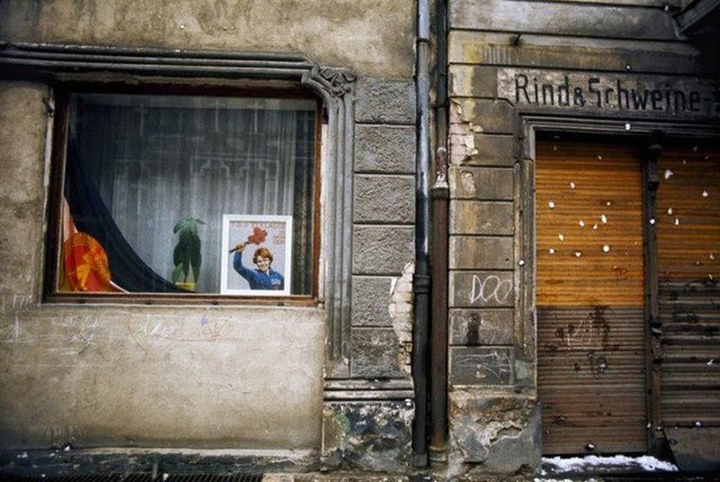 1974_a_storefront_displays_a_propaganda_poster_in_east_berlin.jpg